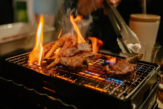 Open flame in enclosed spaces propose a Injury Risks at Backyard BBQs. Pictured in an indoor grill with open flames roasting meat