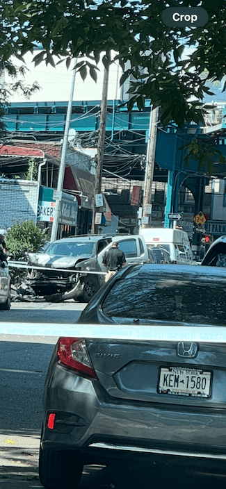 image of the aftermath of a fatal Elmhurst Queens sidewalk crash depicting the car the suspect was driving crashed onto the sidewalk