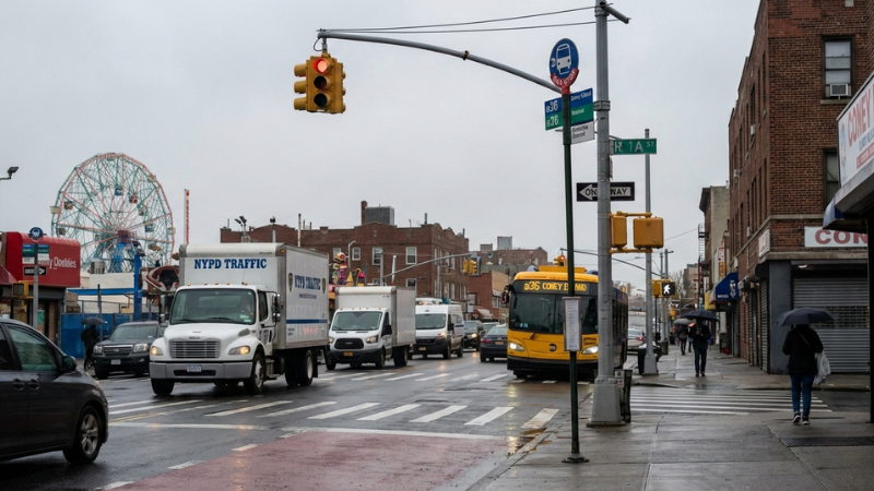 Brooklyn streetscape with bus stop and commercial vehicles symbolizing the B36 Bus Crash in Coney Island.