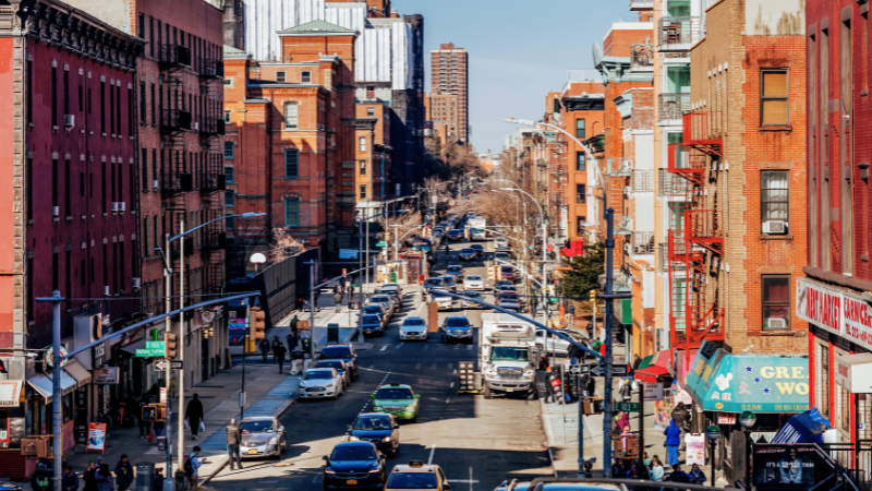 NYC intersection with motorcycle and cars representing Motorcycle Safety Awareness Month Begins in NYC